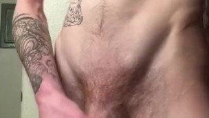 Tattooed boy plays with pink vibrator